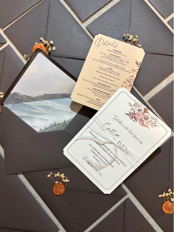 Bespoke wedding invitation suite with floral details and wax seal envelopes