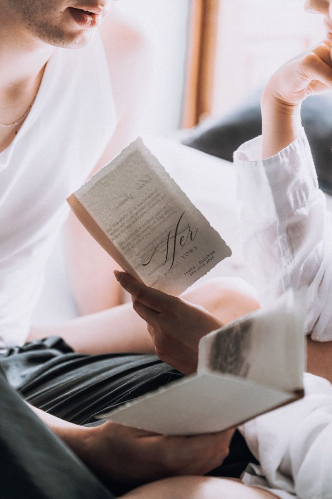 Couple reading personalised wedding vow books