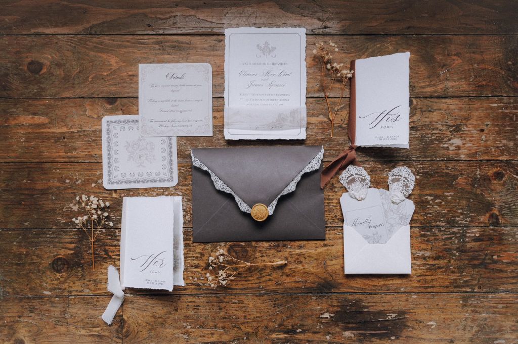 Elegant wedding stationery and vow books flat lay