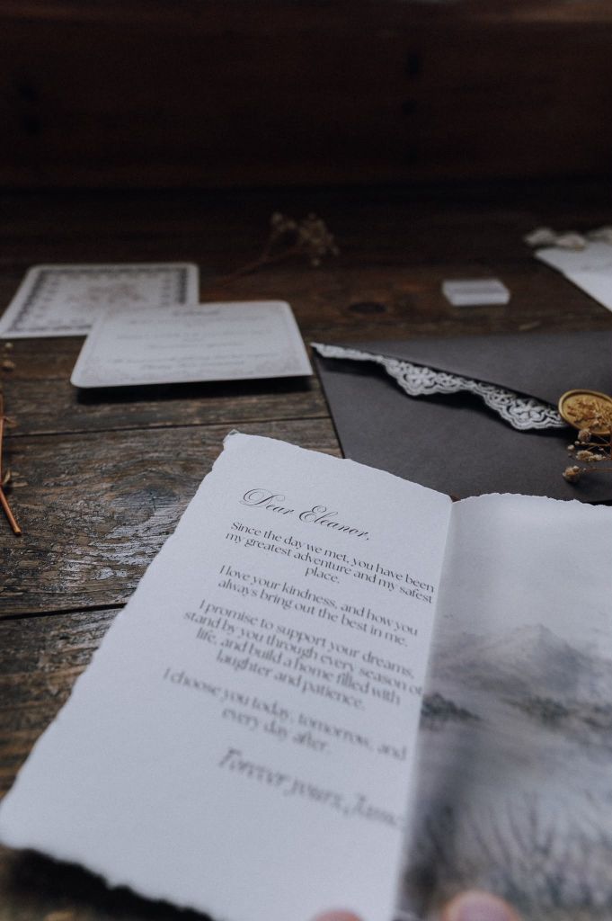 Open wedding vows on a rustic wooden table